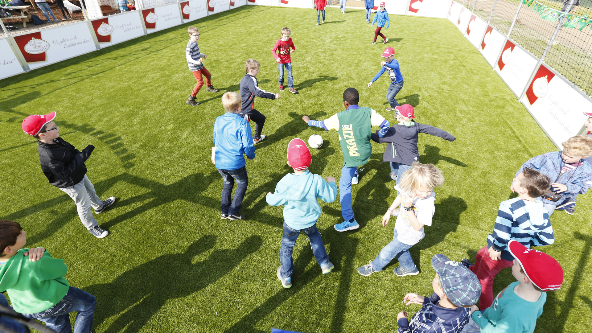 Kids playing soccer in a play area