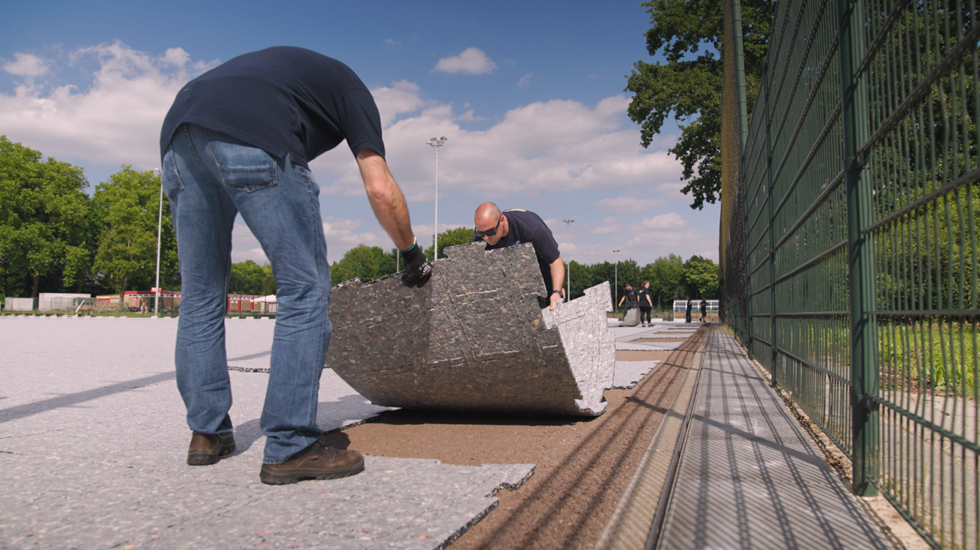 Two men installing ProPlay shock pads